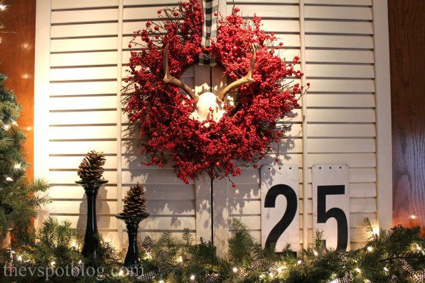 Red wreath with antlers mantel decor